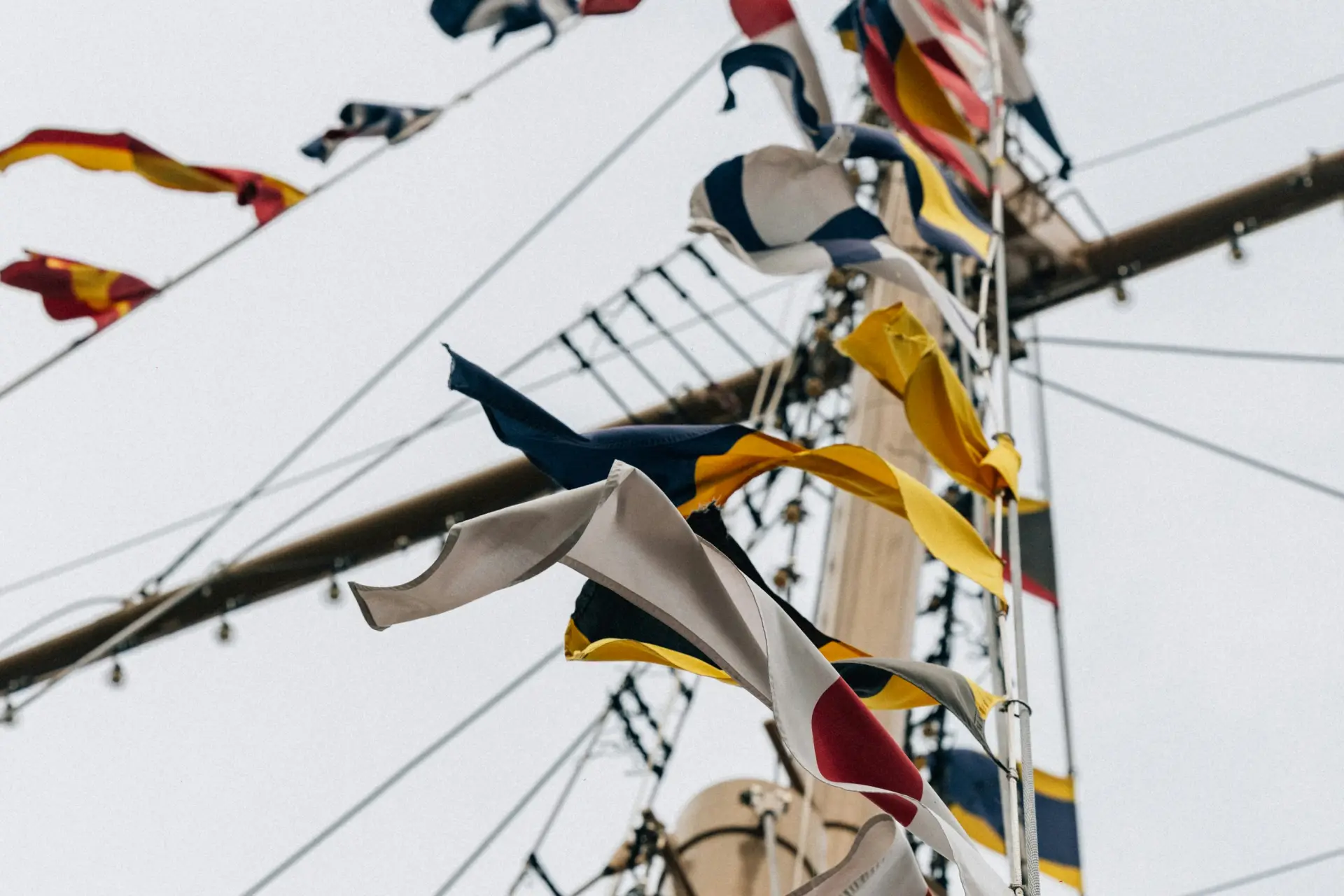 Maritime signal flags fluttering in a ship’s rigging